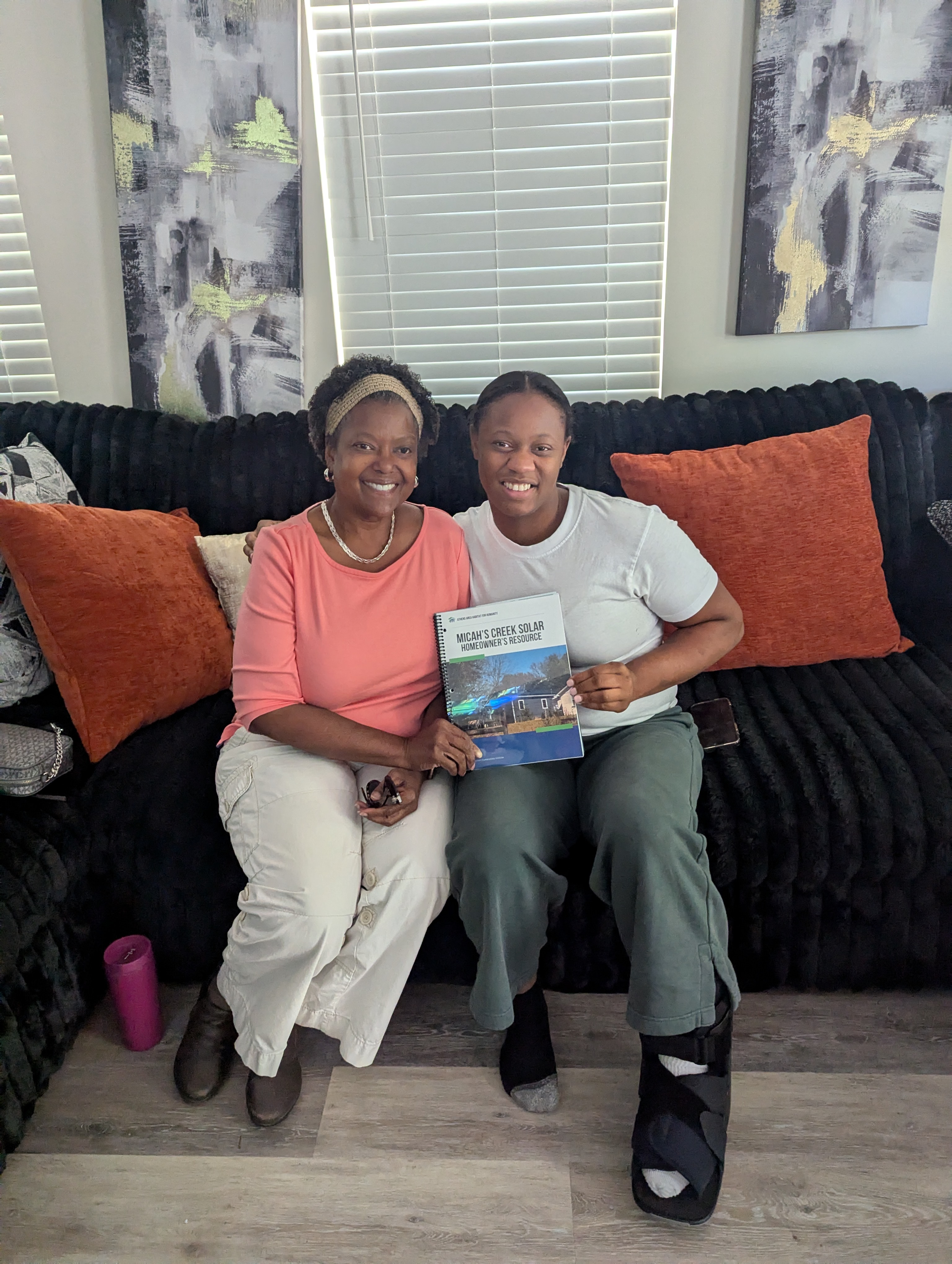 Residents holding Micah's Creek solar homeowner materials