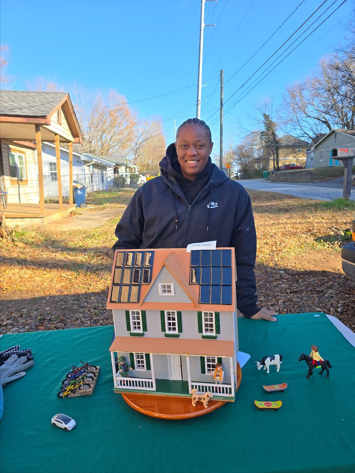 Community member presenting a model solar home